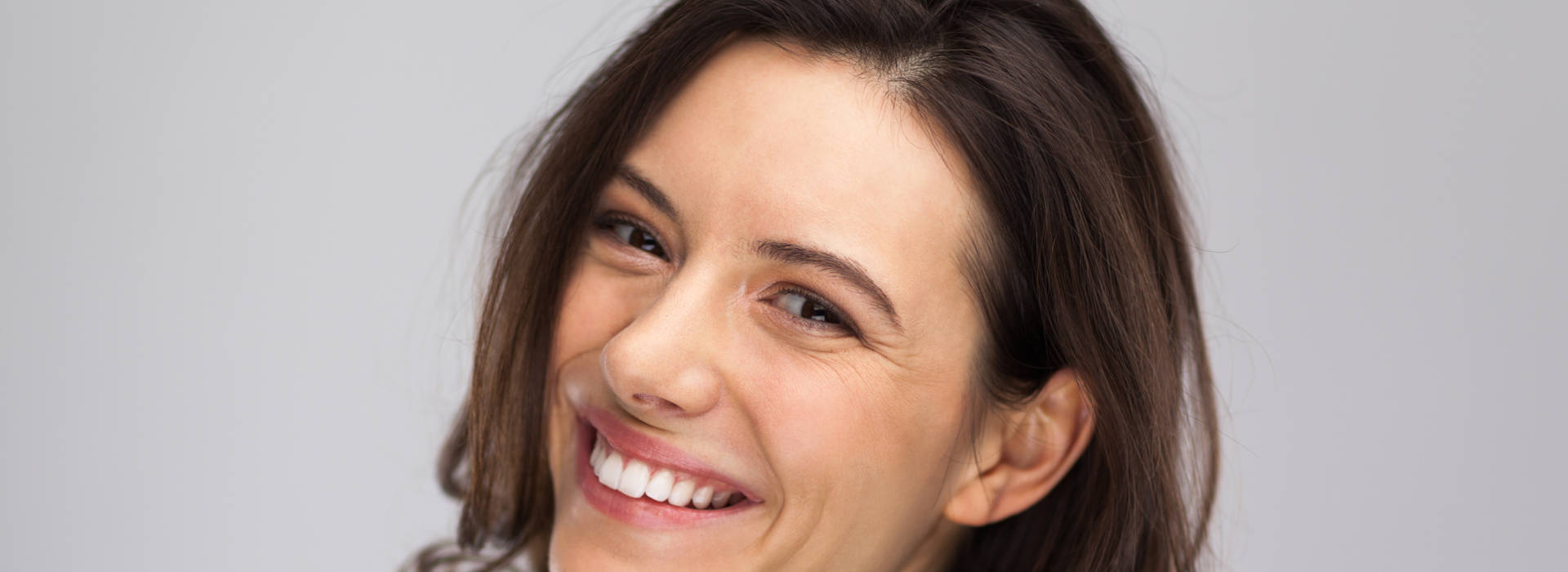 A woman is smiling after semi-permanent makeup (Scalp).